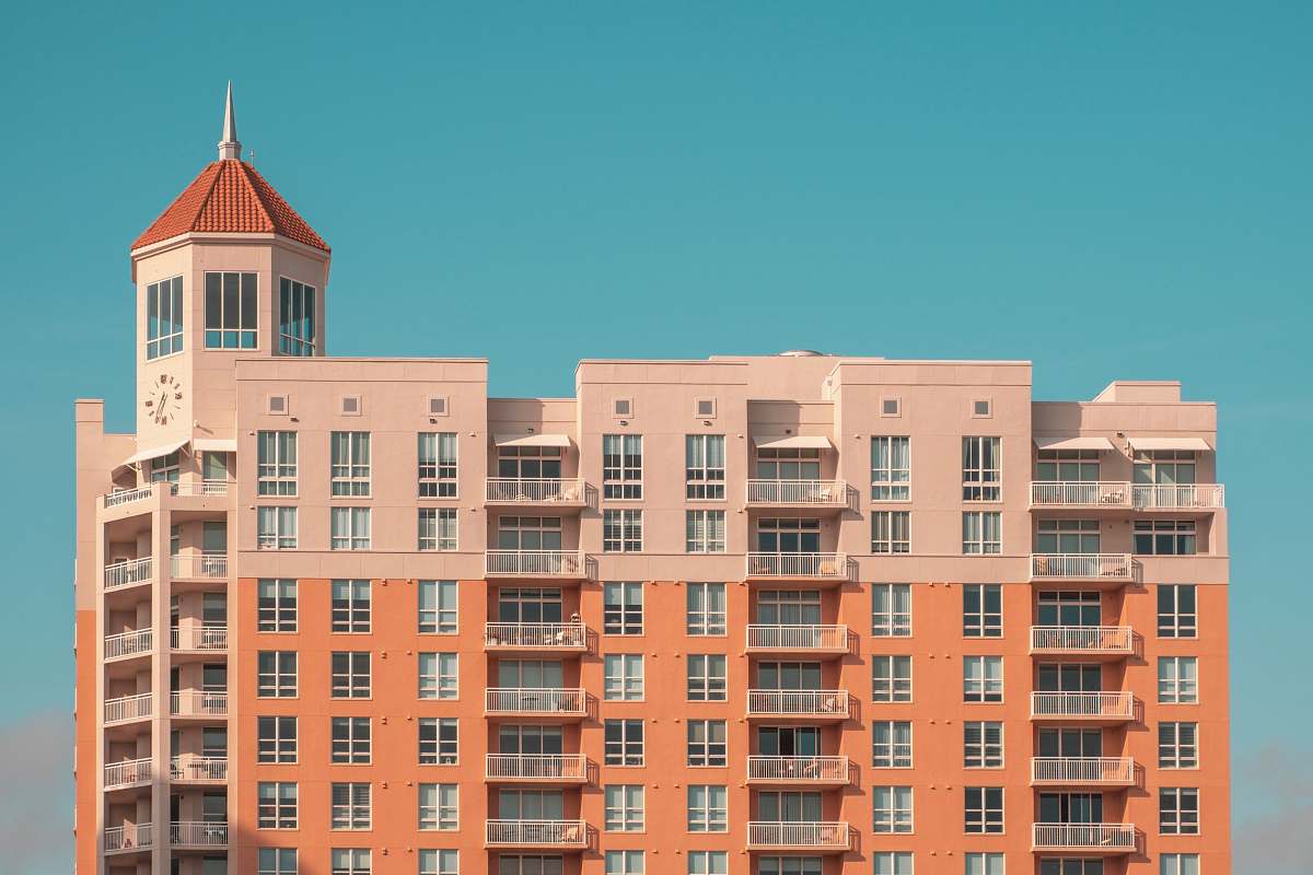 town orange and white concrete building at daytime urban